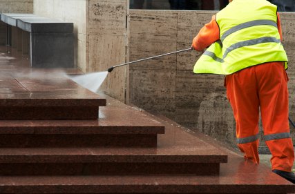 Worker Pressure Washing with emergency services